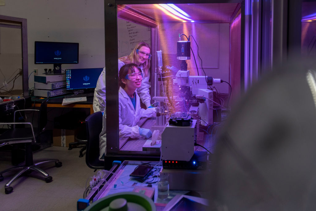 two female students in a lab conducting an experiment