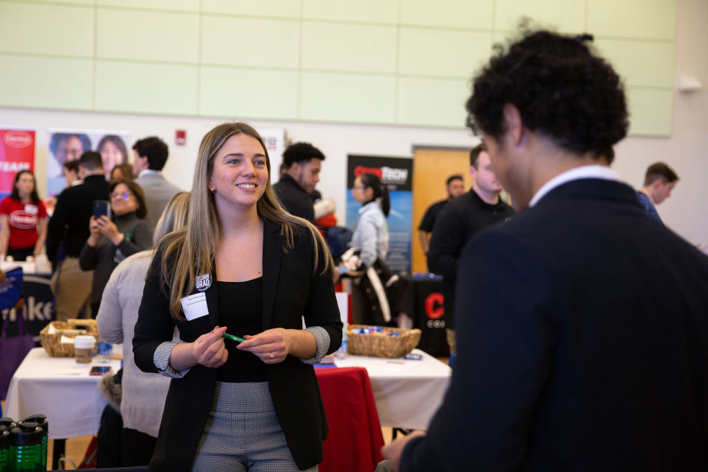 uconn students at a career fair talking